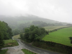 Rivers running down the road and fog on the hills at Col de Lizuniaga